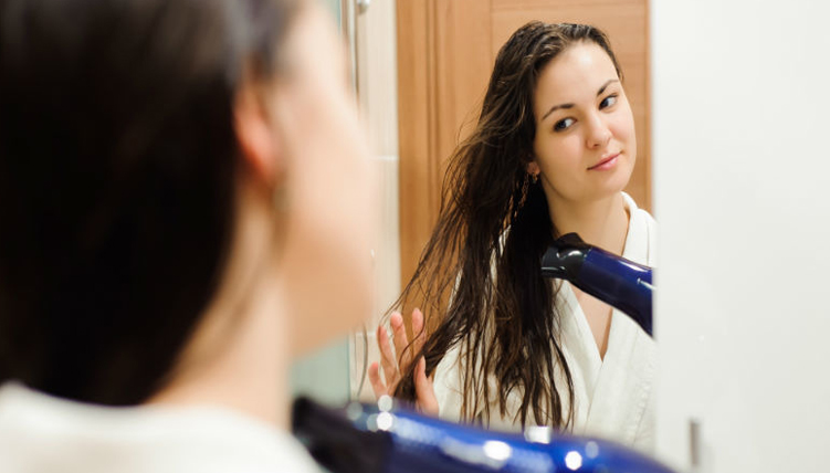 Girl using hair dryer